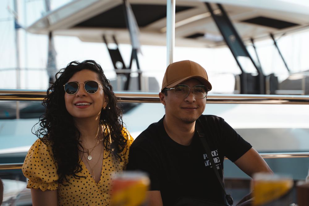 A couple under a boat's bimini, smiling at the camera